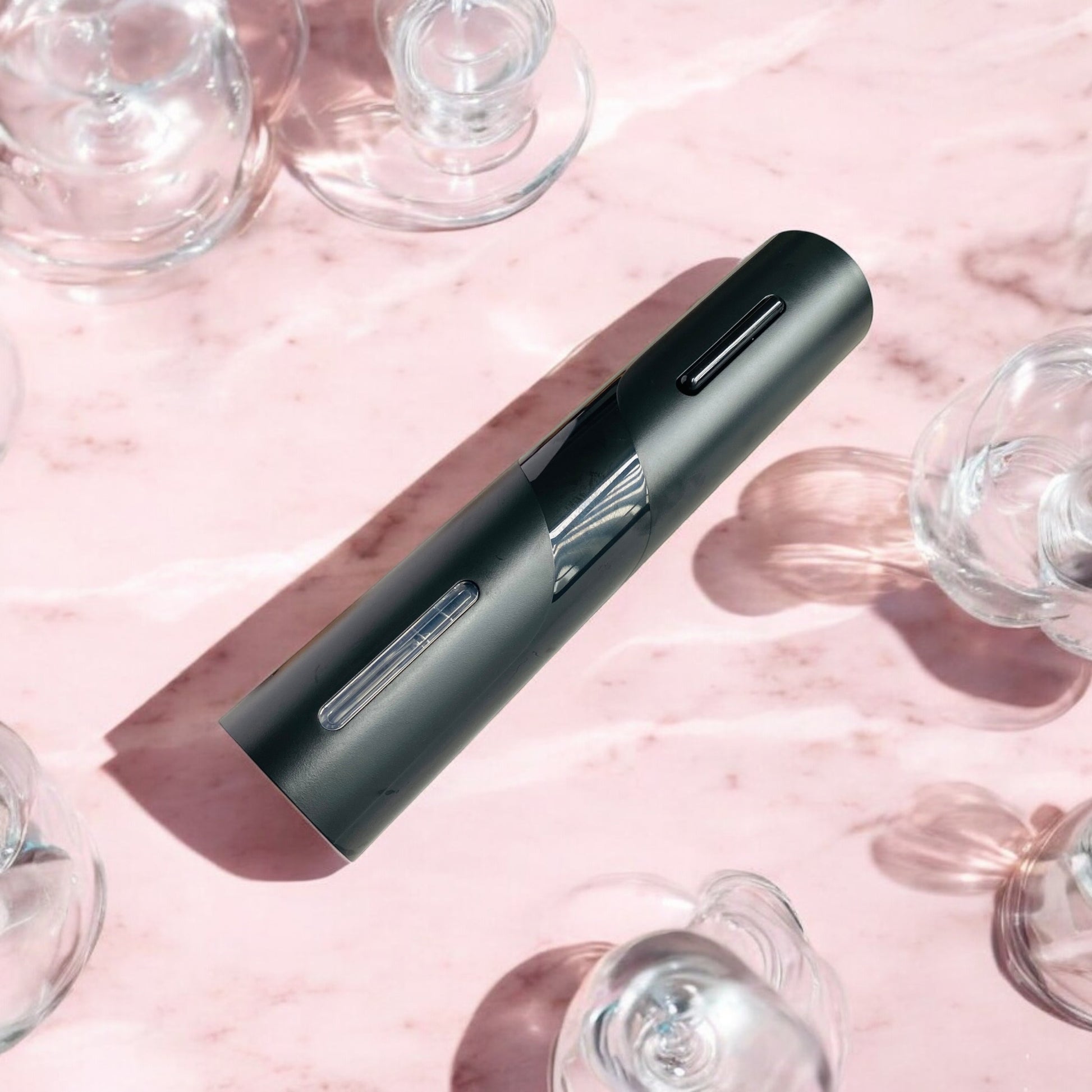 Electric wine opener on a pink marble surface