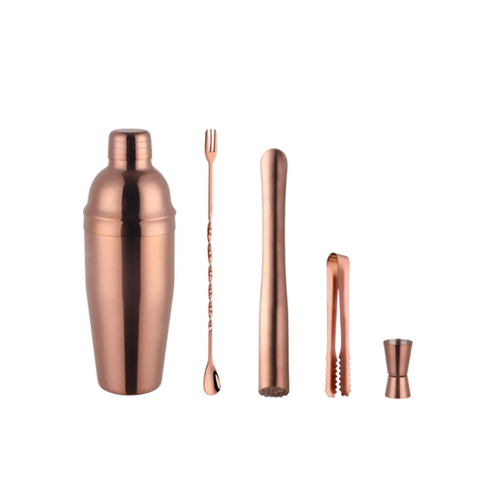 Rose gold cocktail shaker set with a bar spoon, muddler, ice tongs, and double-sided jigger